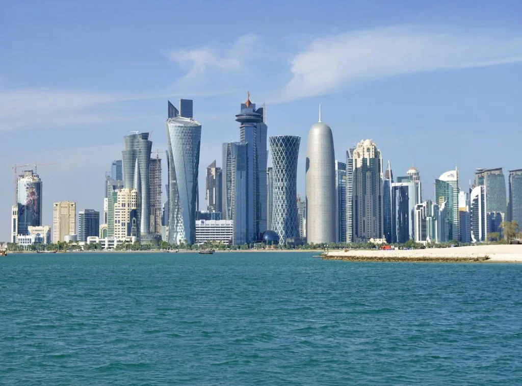 Tourists exploring Doha City highlights including Katara Cultural Village, Souq Waqif, and the Corniche with a licensed guide.