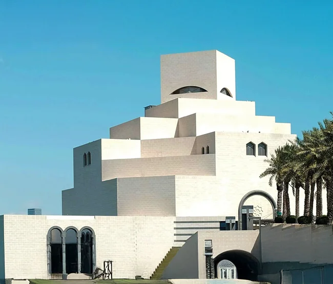 Museum of Islamic Art in Doha, designed by architect I. M. Pei, standing on its own island with the Arabian Gulf and Doha skyline in the background.